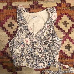 Likely cropped floral shirt